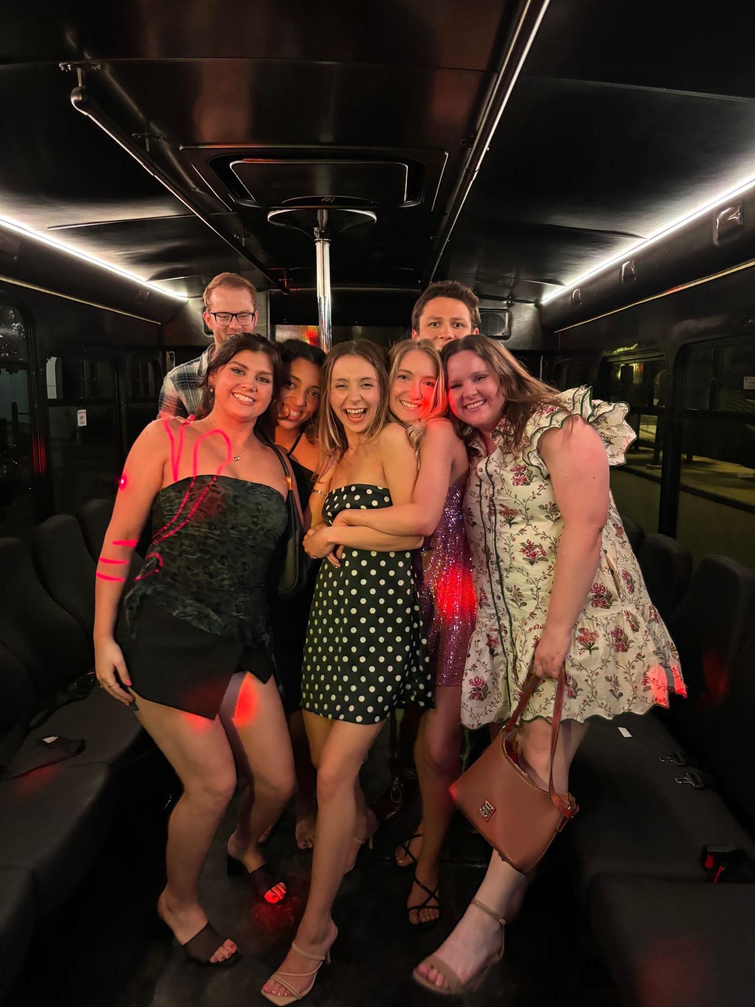 Group celebrating on an AUX party bus
