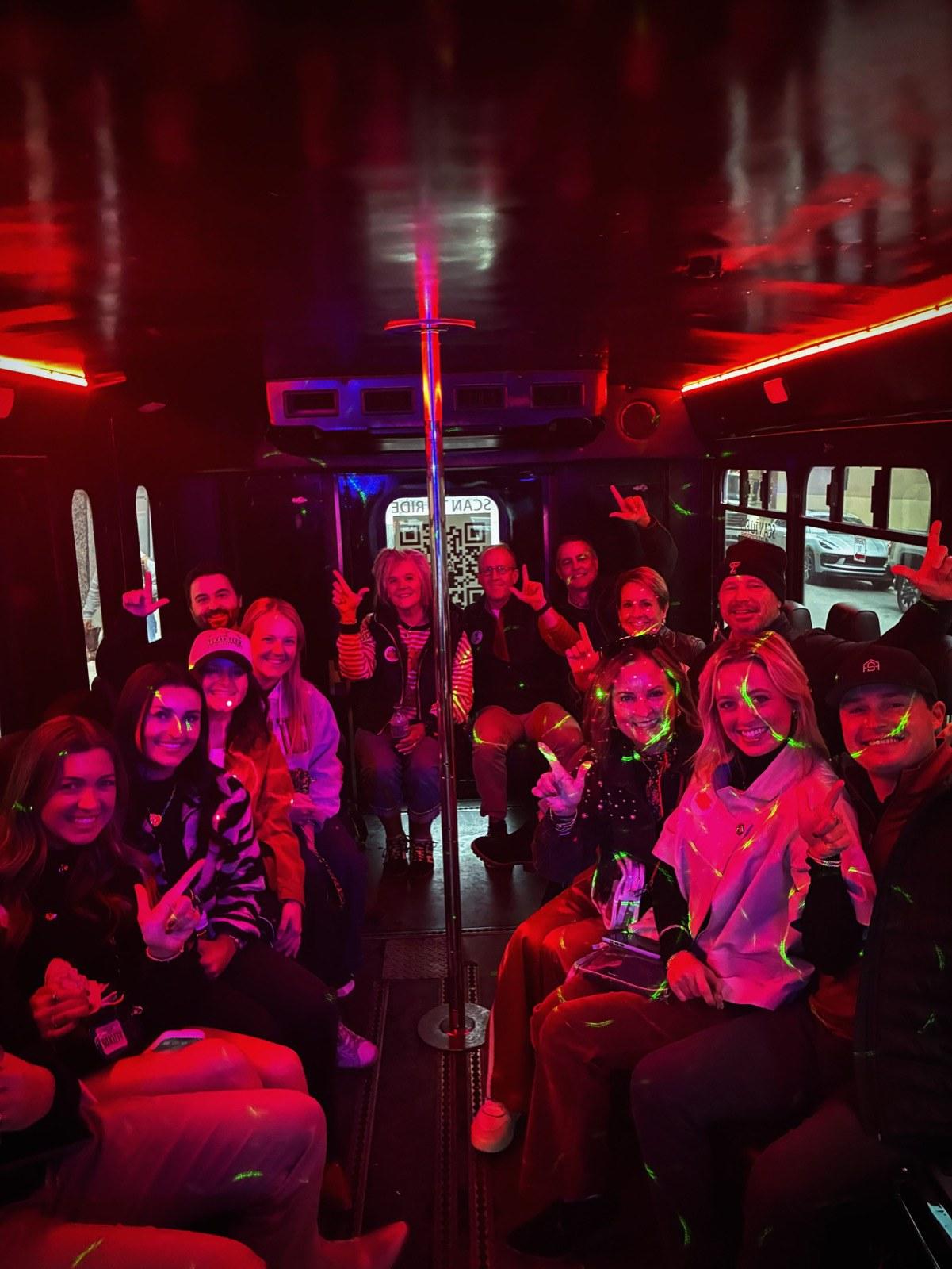 Group celebrating on an AUX party bus